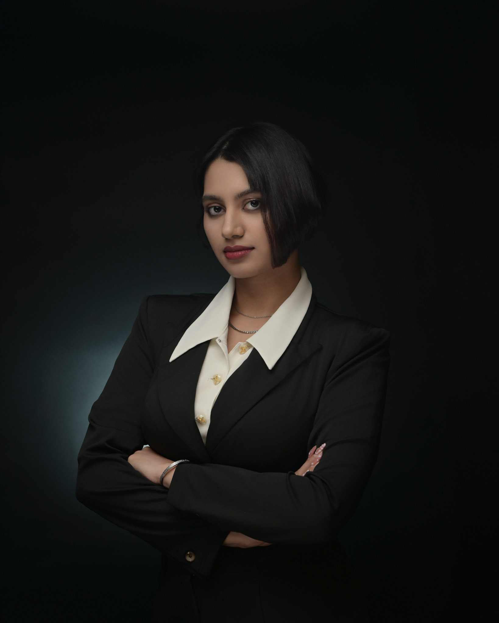 Professional headshot of woman in brown blazer